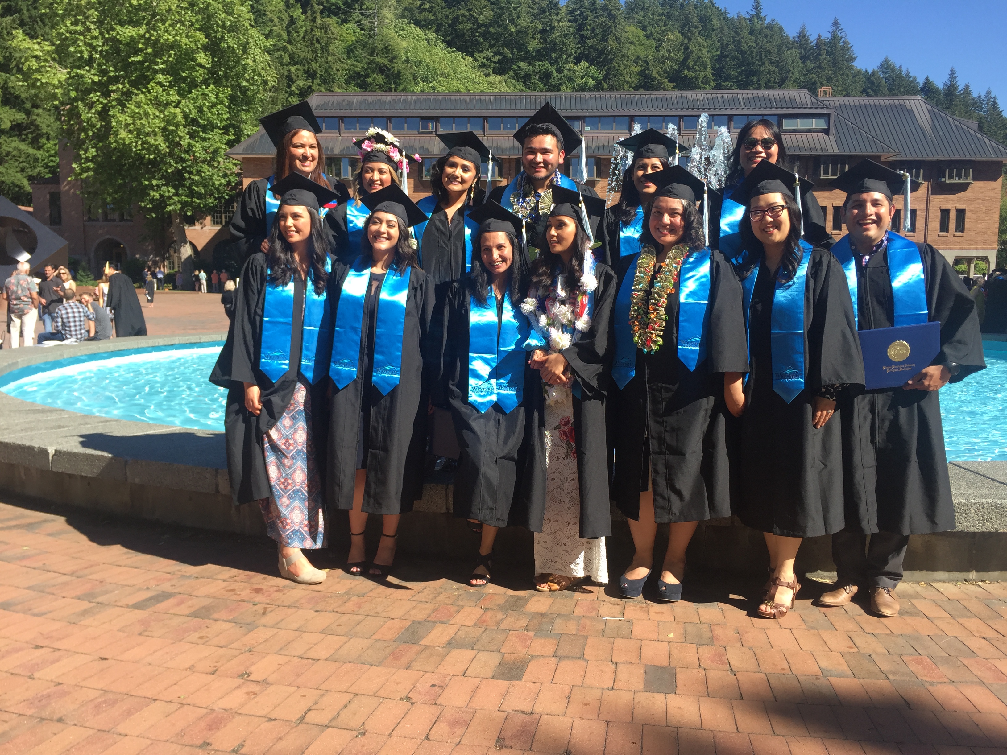 group of future bilingual teacher fellows in graduation robes
