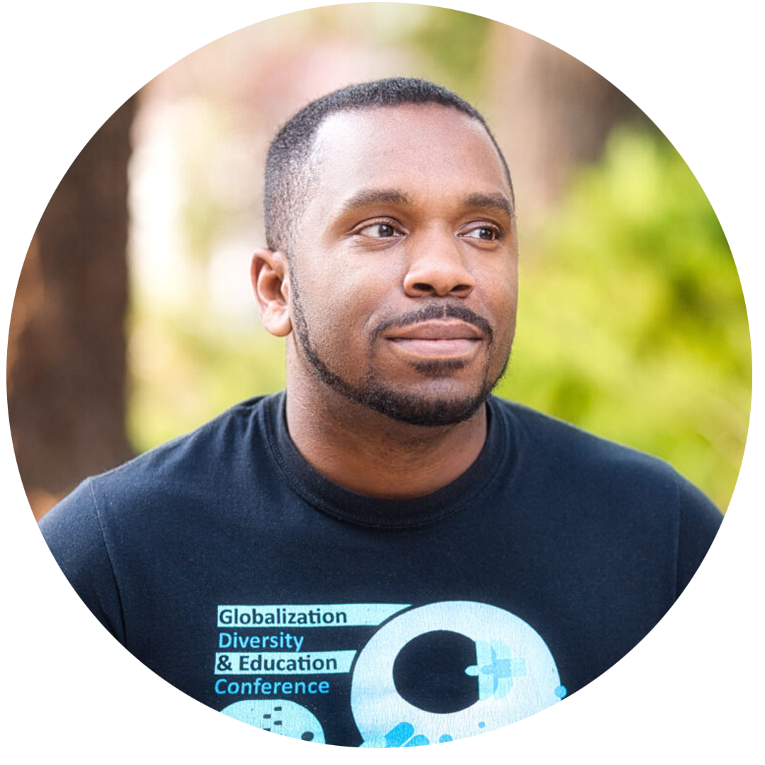 Headshot of Amir Gilmore, wearing a shirt that says "globalization, diversity & Education conference"
