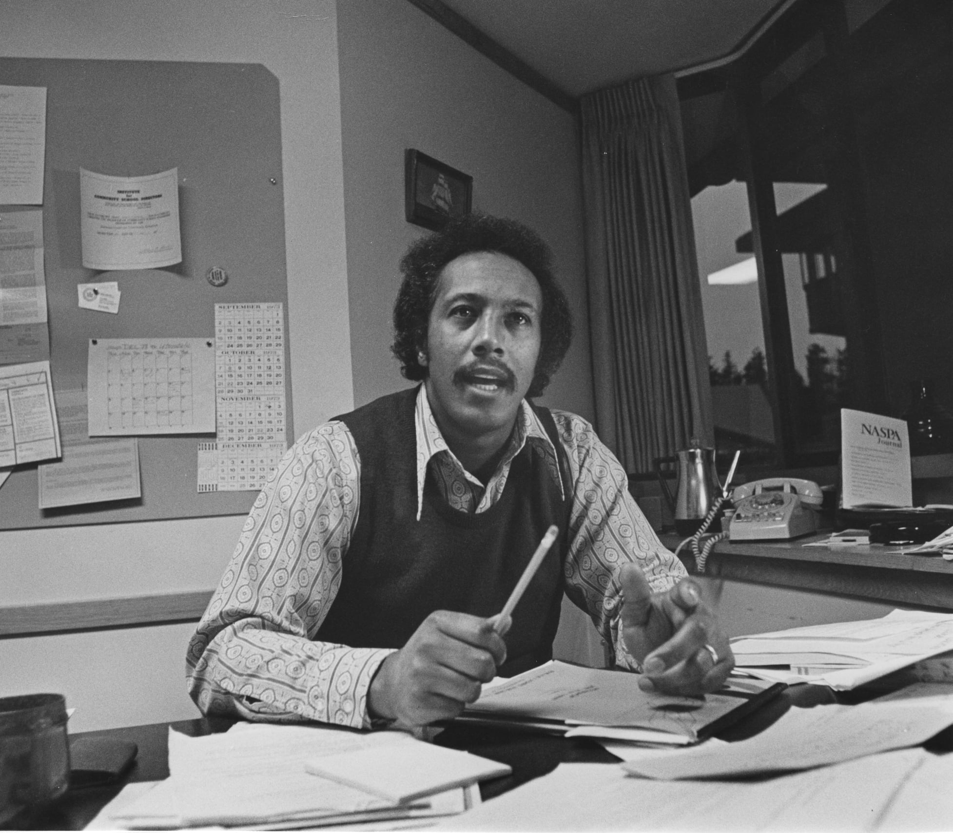 Dr. John Utendale sitting behind his desk in his office