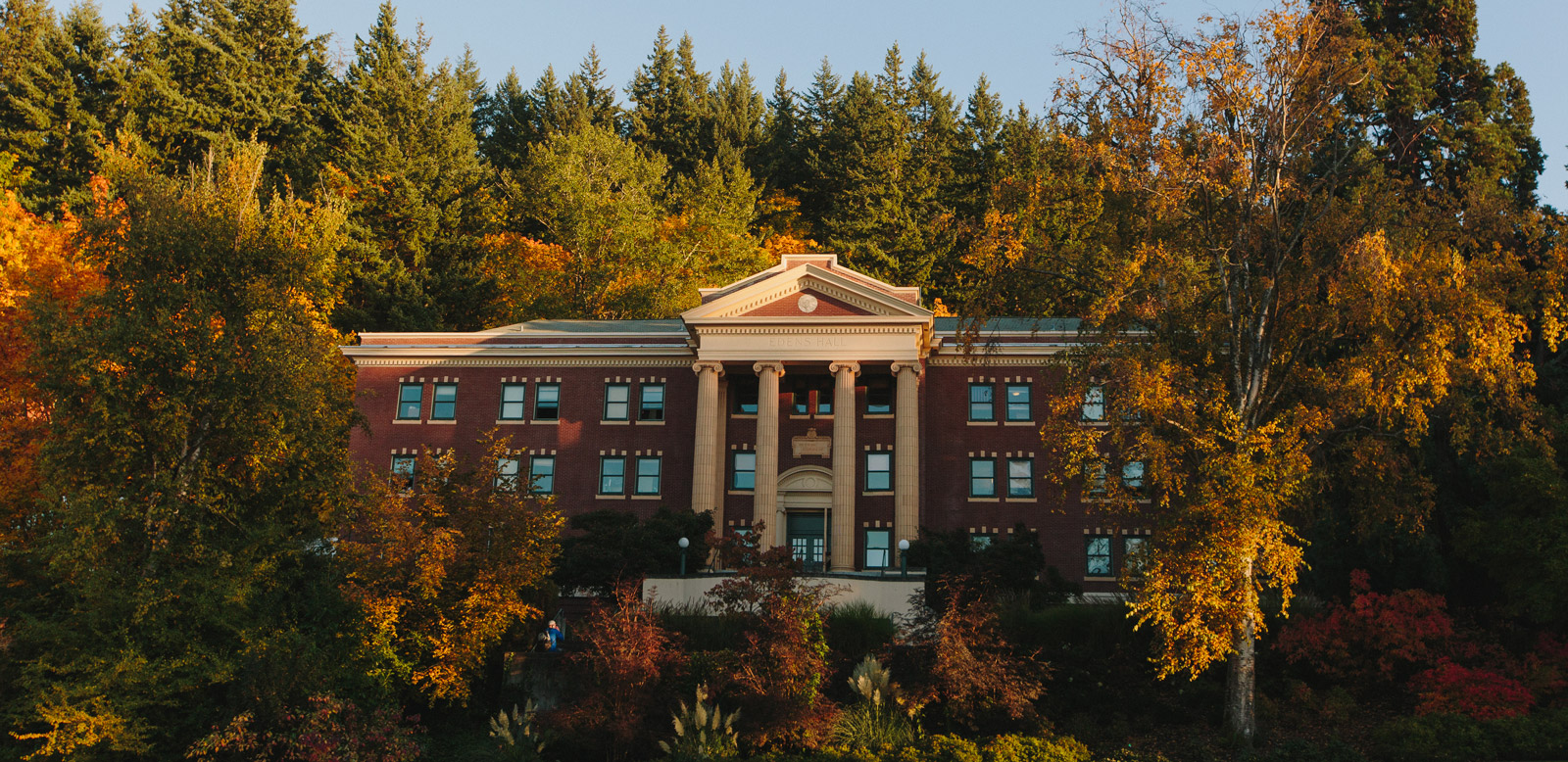 Edens Hall in the fall time, surrounded by trees