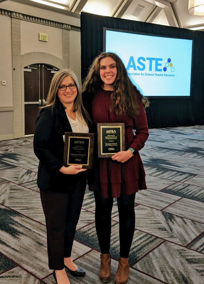 Dr. Debi Hanuscin and Student Spencer Green hold their ASTE Awards
