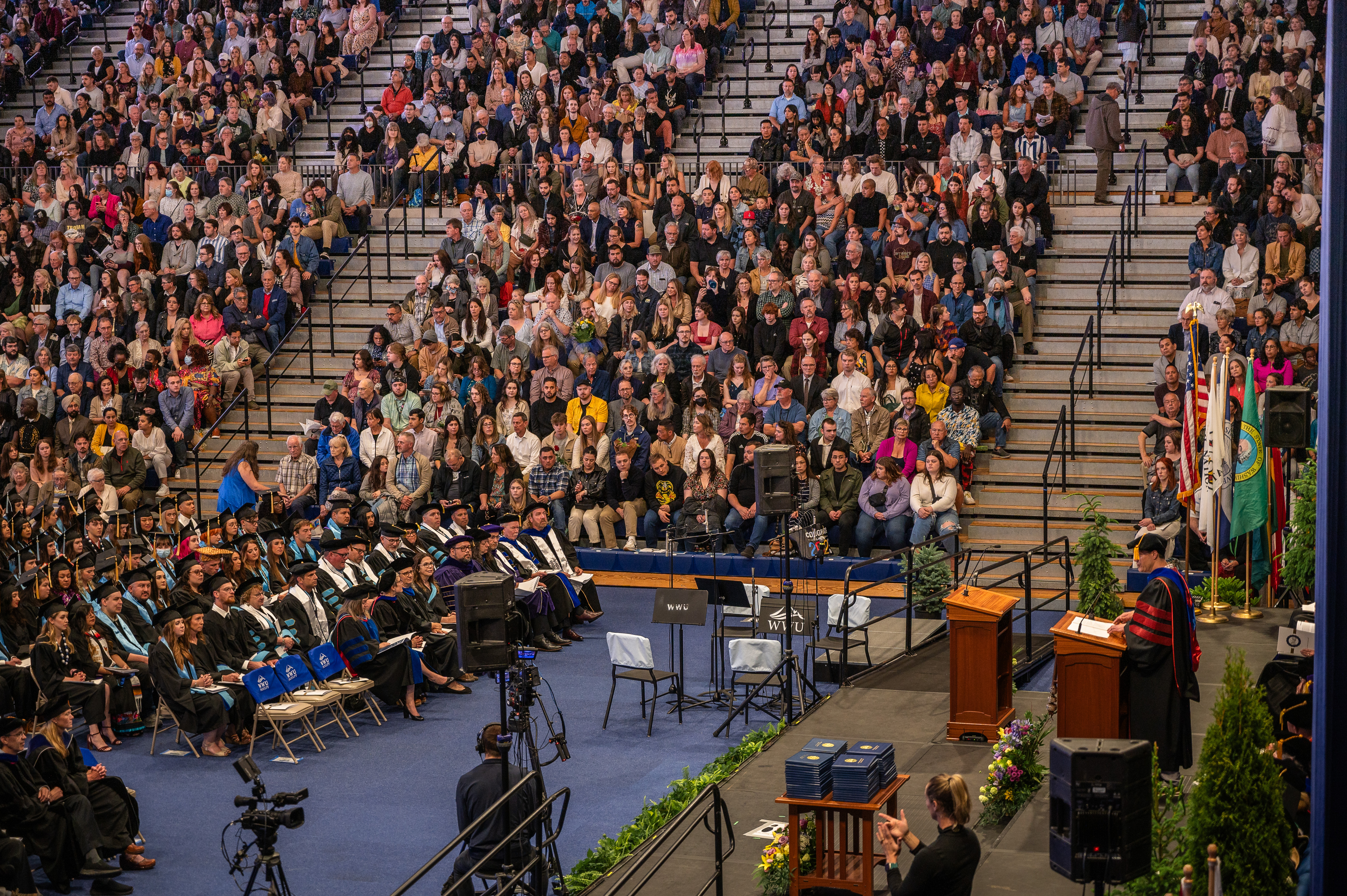 Crowd of students sitting on stairs waiting to receive their diplomas