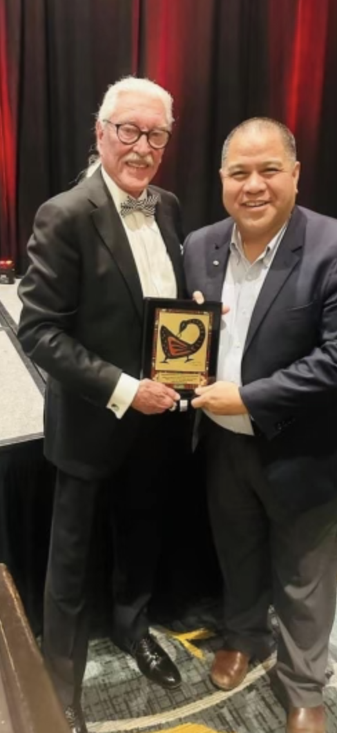 Kevin Roxas receiving the 2023 G. Pritchy Smith Multicultural Educator of the Year Award shaking hands with G. Pritchy Smith