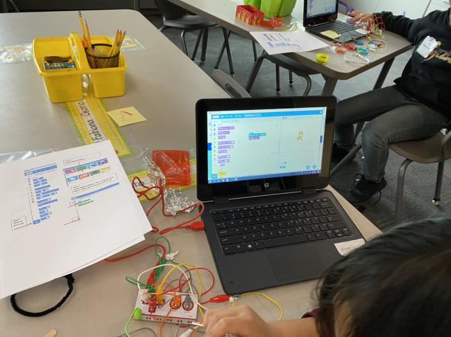 children utilizing a "Makeymake" tech device in the classroom