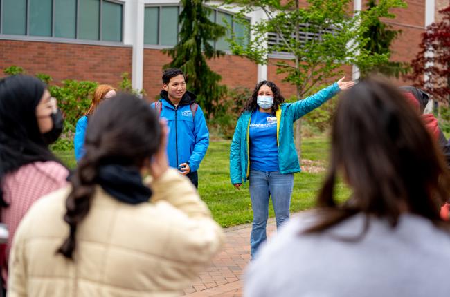 A student mentor guiding a group of students around WWU