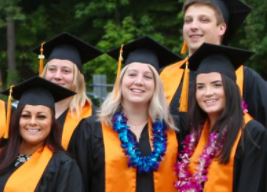 Five smiling graduates in cap and gown on graduation day