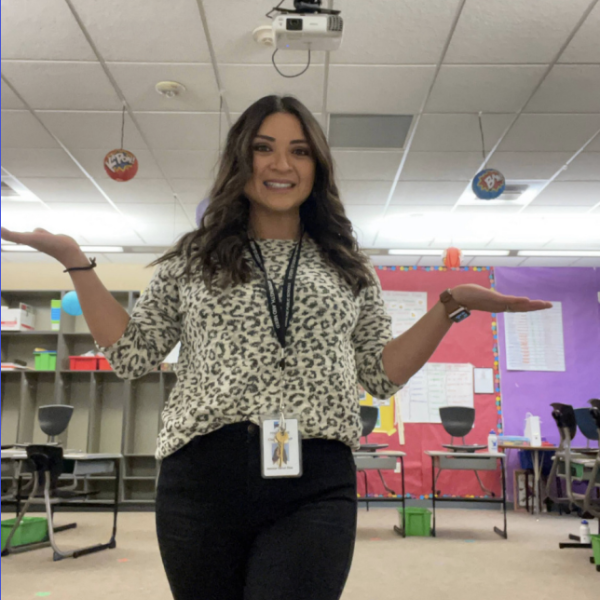 Jessica Diaz standing in her classroom with her arms up at her sides